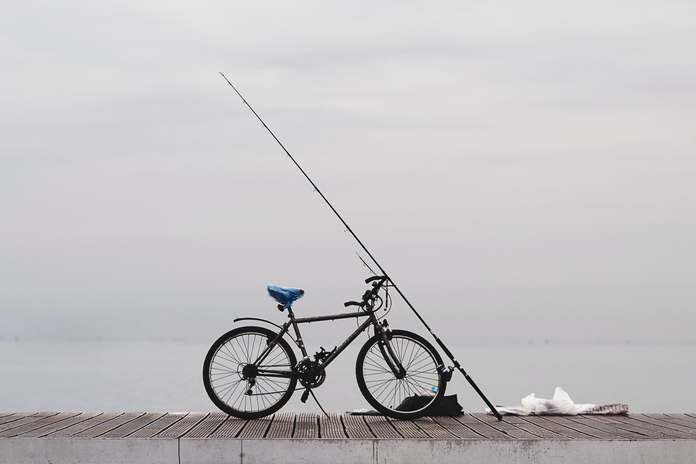 bicycle on dock with fishing pole