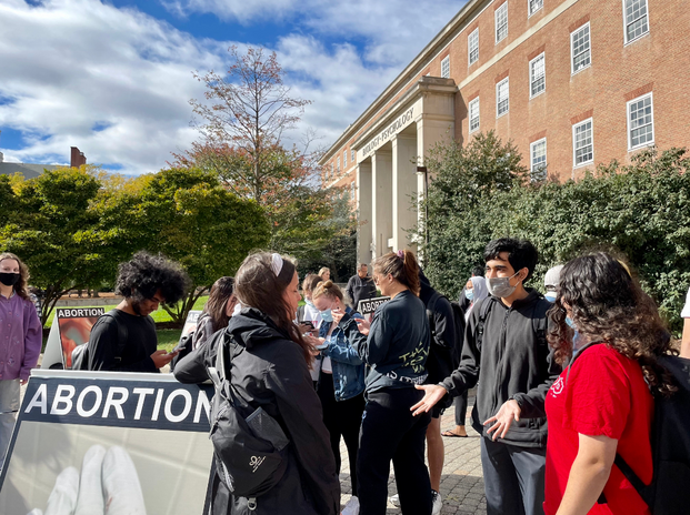 University of Maryland students arguing/discussing with an anti abortion protester