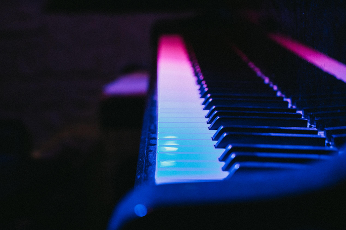 Piano with blue and pink lighting by Gerold Hinzen