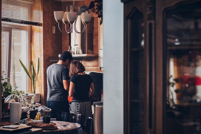 man and woman cookingjpg by Unsplash