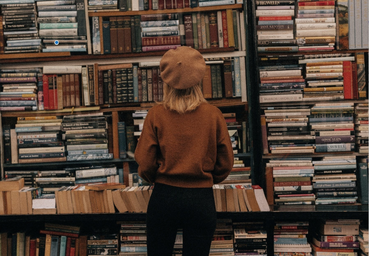 Sarah in front of books