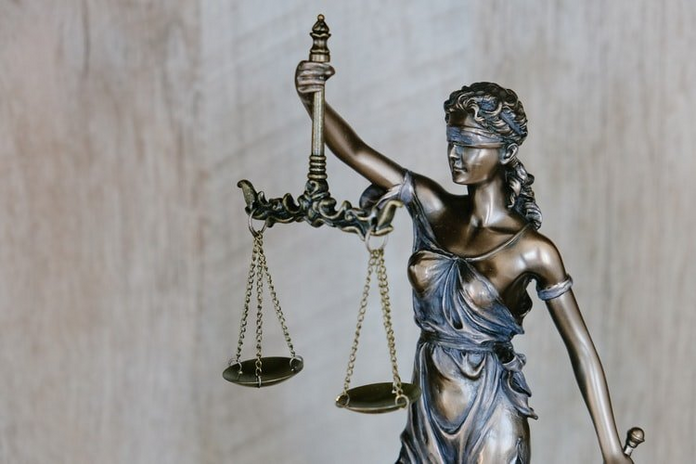 Woman holding justice weights