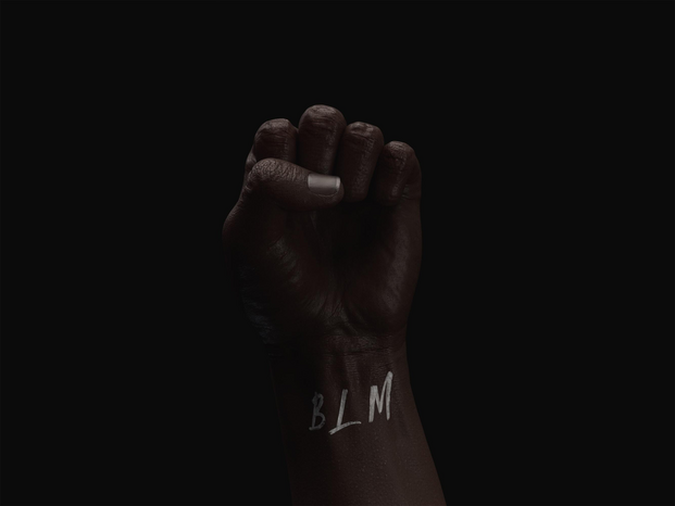 black fist with BLM written on the wrist by Mattia Faloretti on Unsplash