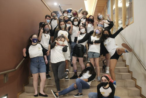 masked group photo on stairs