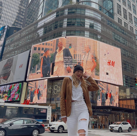 Girl in front of big screen in New York City
