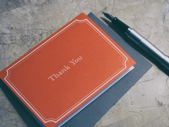 Red thank you note and pen