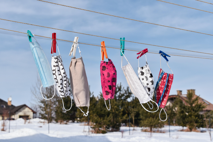masks hanging on clothing pegs