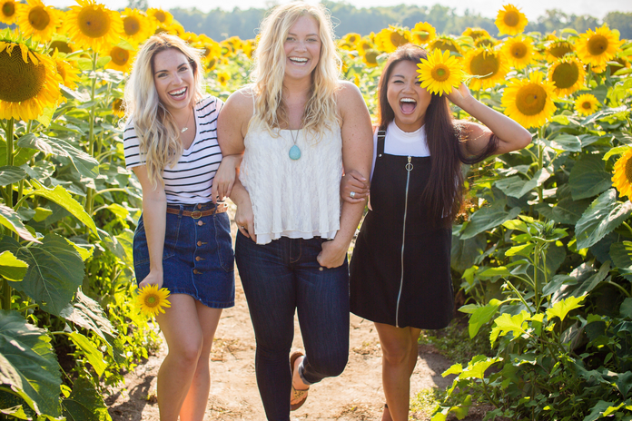friends in sunflower field by Courtney Cook