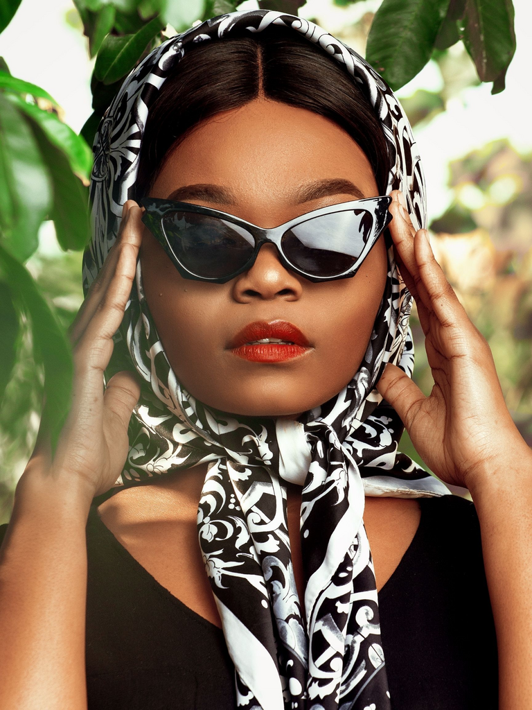 Woman with silk headscarf and sunglasses