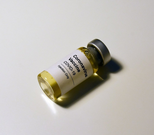 Pill bottle labeled Coronavirus Vaccine by Hakan Nural
