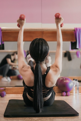 woman weightlifting in gym by Yulissa Tagle