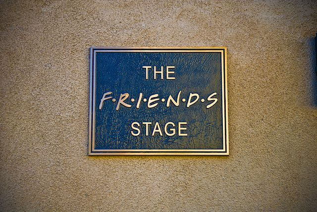 plaque on a brick wall saying \"The friends stage\"