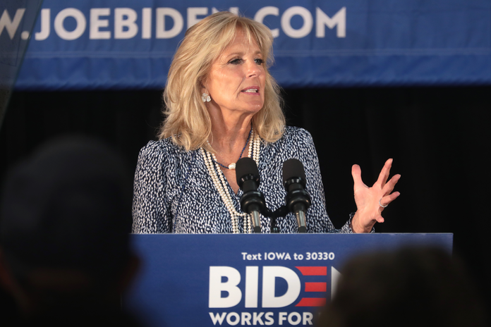 Jill Biden at a podium, speaking out to an audience.