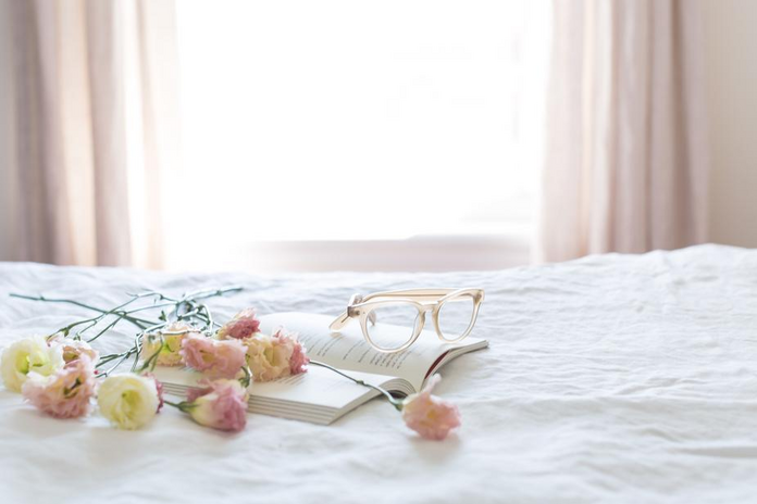 Flowers on book, along with glasses