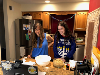 Leah Packer and Rachel Packer cooking together