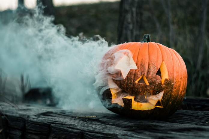 pumpkin with white smoke billowing from it by Colton Sturgeon