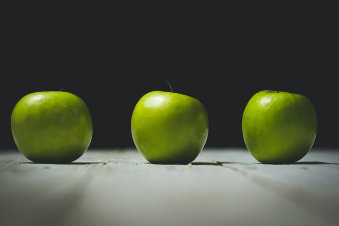 Three green apples by Unsplash