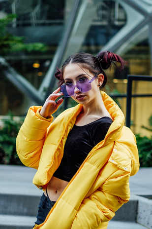 Bristol uk woman in yellow puffer coat and purple sunglasses bristol fashion