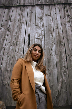 Woman in blazer against wooden background