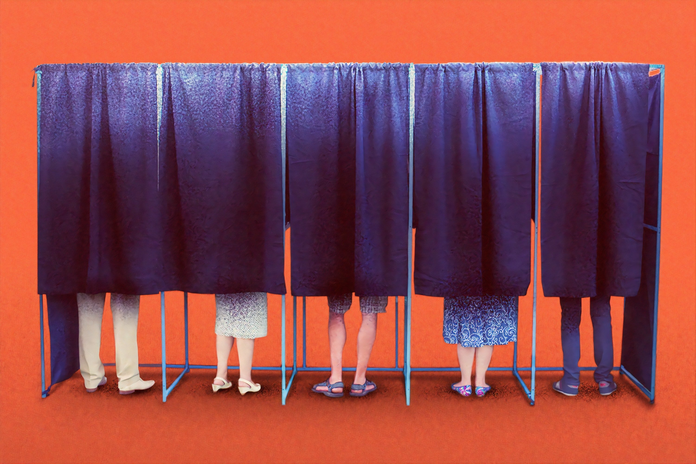 people voting in booths by Morning Brew on Unsplash