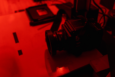 black camera on a table in red lighting