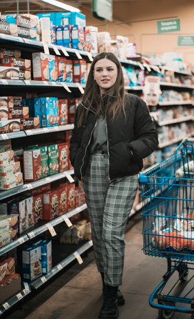 woman wearing puffer coat and plaid trousers by Marie Michele Bouchard on Unsplash