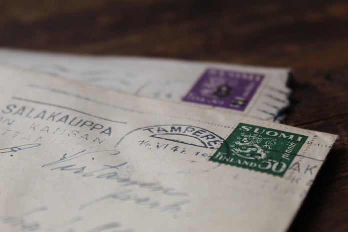 close up of old letters with printed writing and stamps