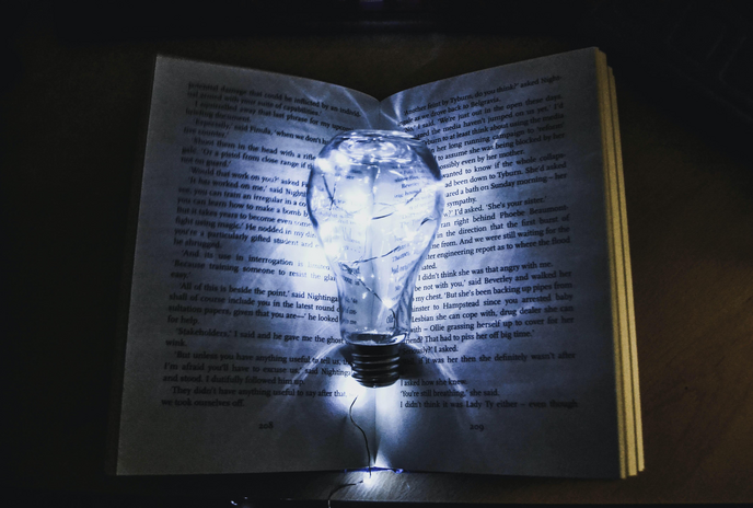 book lit up with a lightbulb