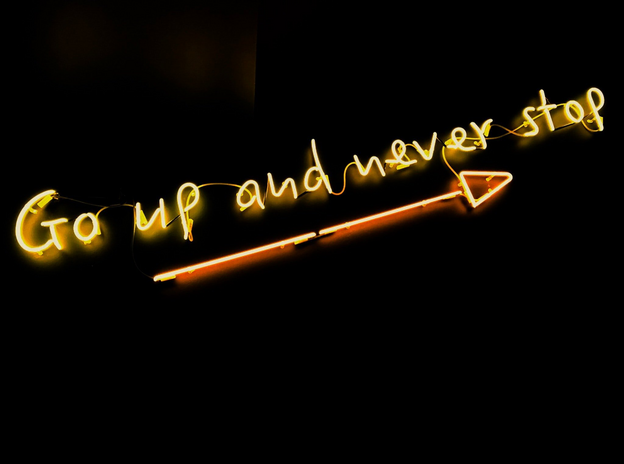 neon quote saying go up and never stop by Fab Lentz
