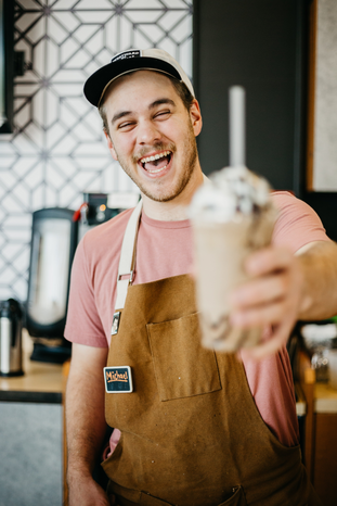 barista holding drink by Vince Flemming from Unsplash
