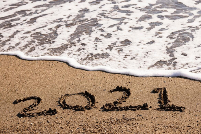 Beach with \"2021\" written in the sand