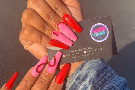 manicured hand holding business card