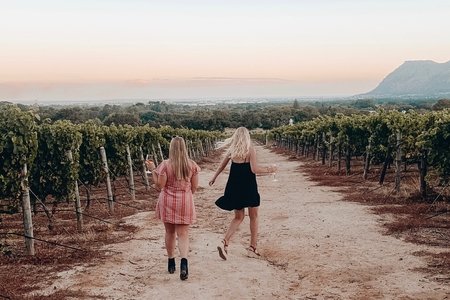 dancing through a wine vineyard in south africa