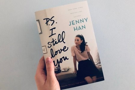 Someone holding a copy of the book "P.S. I Still Love You"