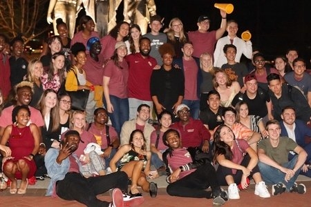 Students in a large crowd smiling for a photo
