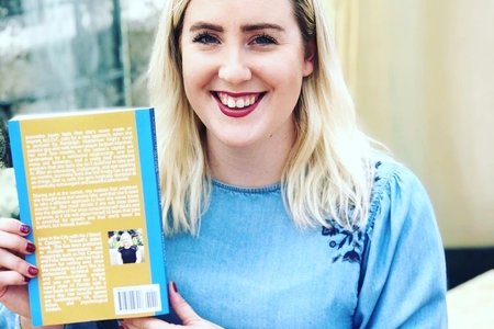 Caroline Trussell holding her novel
