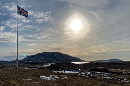 Icelandic flag with scenic background