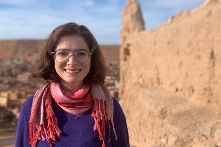 Woman in pink scarf in a desert