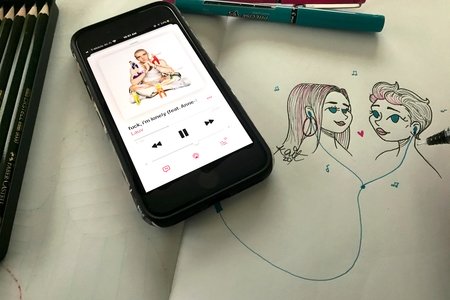 A drawing of two girls listening to music together