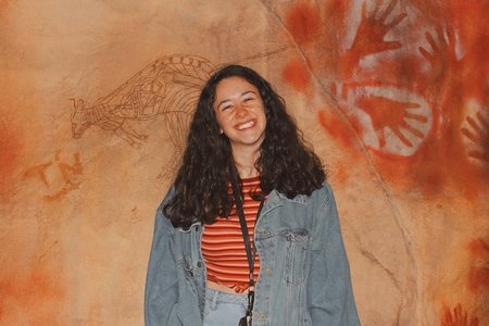 me in front of a wall with hand prints on it