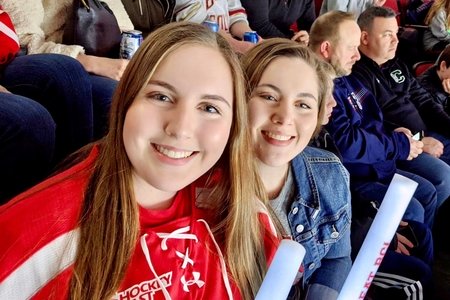 sisters at a Boston University hockey game