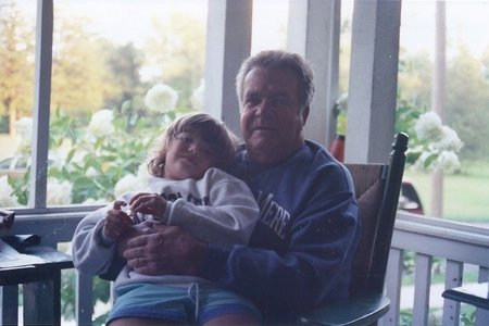 child sitting on porch with man