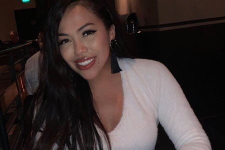 Woman sitting at a table smiling