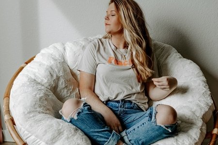 woman sitting in a round chair