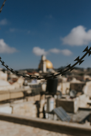 A string of barbed wire in front of the Dome of the Rock