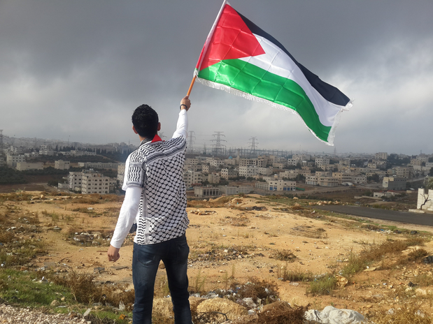 Man waving a Palestinian flag