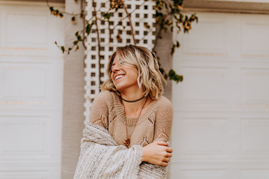 happy girl in sweater laughing