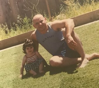 Mary and her father sitting on the grass.