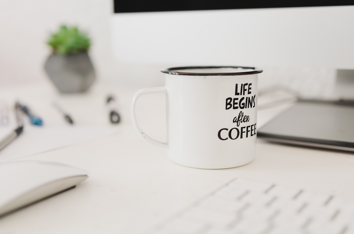 white coffee mug on desk Unsplash