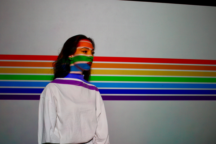 woman covered in rainbow stripes